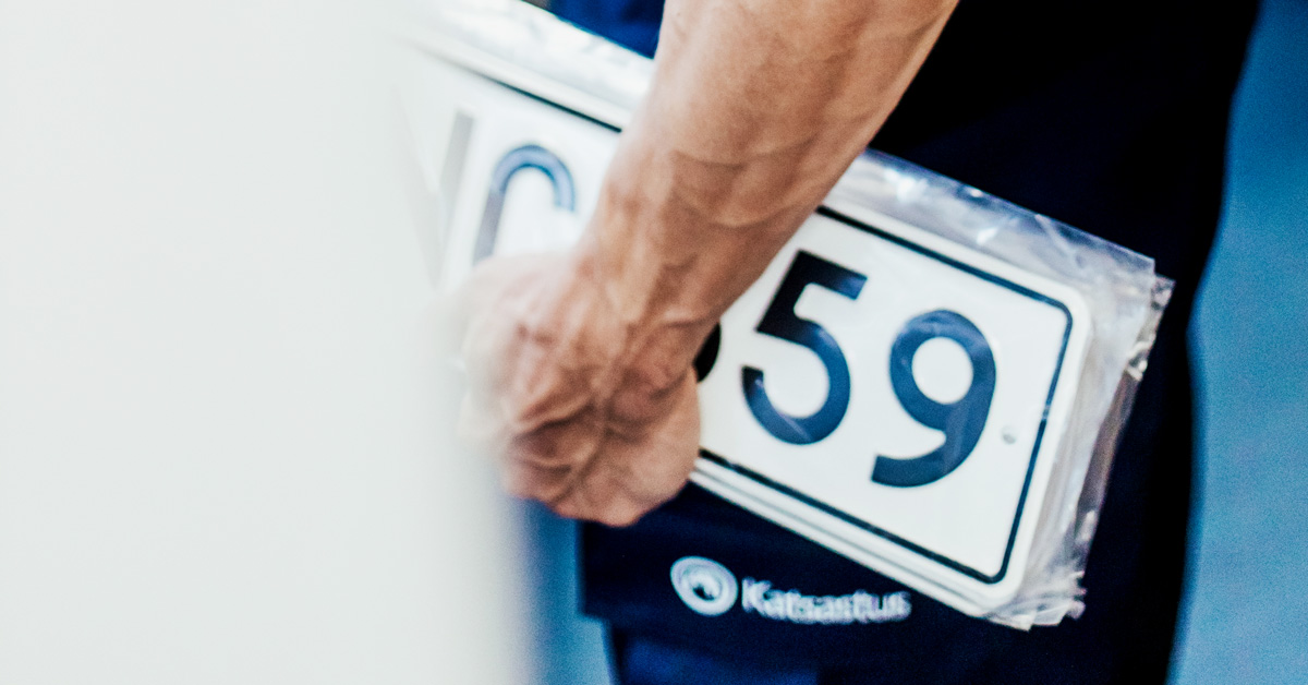 An inspector holding license plates.